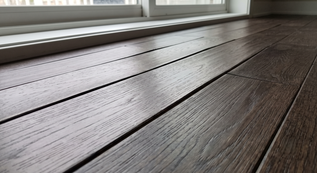 Severe wood flooring lifting or cupping caused by moisture.